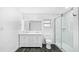 Modern bathroom featuring double vanity, stylish mirror and a glass-enclosed shower at 8804 Harrison Rd, Lakeland, FL 33810