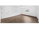 A brightly lit bedroom featuring a light-colored floor and a simple window at 8804 Harrison Rd, Lakeland, FL 33810