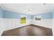 Bright and airy bedroom with wood-look floors, wainscoting and ample natural light at 8804 Harrison Rd, Lakeland, FL 33810