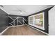 This dark bedroom design features wood-look floors, large window and custom wall trim at 8804 Harrison Rd, Lakeland, FL 33810