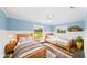 Comfortable bedroom with wood-look floors, ceiling fan and two twin beds at 8804 Harrison Rd, Lakeland, FL 33810