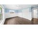 Spacious bedroom with wood-look floors, walk-in closet and access to an attached bathroom at 8804 Harrison Rd, Lakeland, FL 33810