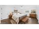 Bedroom featuring wood-look floors, a ceiling fan, and neutral tones at 8804 Harrison Rd, Lakeland, FL 33810