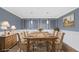 Staged dining room features decorative wall paneling, modern lighting and a rustic table with seating for eight at 8804 Harrison Rd, Lakeland, FL 33810