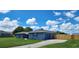 Stylish home featuring a well-maintained lawn, side garage and matching storage shed at 8804 Harrison Rd, Lakeland, FL 33810