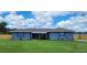 Charming single story home boasts a spacious front yard and a quaint covered entryway at 8804 Harrison Rd, Lakeland, FL 33810