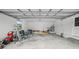 A spacious and cluttered garage interior with ample storage and natural light at 8804 Harrison Rd, Lakeland, FL 33810