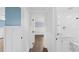 Well-lit hallway showcasing hardwood floors and seamless access to the bathroom at 8804 Harrison Rd, Lakeland, FL 33810