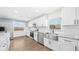 Modern kitchen featuring stainless steel appliances, white cabinets and an island sink at 8804 Harrison Rd, Lakeland, FL 33810