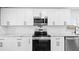 Modern kitchen features white cabinets, stainless steel appliances, and granite countertops at 8804 Harrison Rd, Lakeland, FL 33810