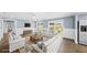 Staged living room with neutral furniture, wood floors, and wainscoting at 8804 Harrison Rd, Lakeland, FL 33810