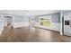 Open-concept living area features wood floors, large windows, and white wainscoting at 8804 Harrison Rd, Lakeland, FL 33810