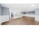 Open concept living room flows to kitchen with white cabinets, stone countertops and stainless steel appliances at 8804 Harrison Rd, Lakeland, FL 33810