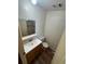 Compact bathroom featuring a single sink vanity and an adjacent toilet under a recessed light at 11407 Bobwhite Blvd, Leesburg, FL 34788