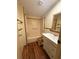 Bathroom features a bathtub-shower combo, toilet with wood-colored seat, and single sink vanity at 11407 Bobwhite Blvd, Leesburg, FL 34788