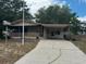 Charming single-story home with a carport, screened porch and well-maintained landscaping at 11407 Bobwhite Blvd, Leesburg, FL 34788