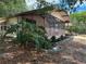 Charming single-story home with a large screened porch and mature landscaping at 11407 Bobwhite Blvd, Leesburg, FL 34788