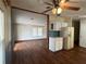 Open-concept eat-in kitchen featuring white cabinets, adjoining the living room space at 11407 Bobwhite Blvd, Leesburg, FL 34788