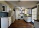 Bright kitchen with white cabinetry, modern appliances, and hardwood floors at 11407 Bobwhite Blvd, Leesburg, FL 34788