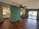 Open-concept living room with hardwood floors flowing into adjacent kitchen at 11407 Bobwhite Blvd, Leesburg, FL 34788