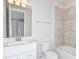 Bathroom features a single vanity, tile shower, and large mirror at 1403 Hamilton Way, Lake Alfred, FL 33850