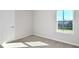 A well-lit room with neutral carpet, white walls, and a window providing natural light at 1403 Hamilton Way, Lake Alfred, FL 33850