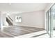 Spacious living room features stairs with dark railings, hardwood floors, and a sliding glass door at 1403 Hamilton Way, Lake Alfred, FL 33850