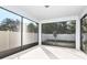 A screened-in patio featuring white concrete flooring and views of the fenced backyard at 1403 Hamilton Way, Lake Alfred, FL 33850
