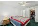 Comfortable bedroom features neutral walls, ceiling fan, and closet storage at 30653 Pga Dr, Sorrento, FL 32776