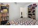 Bedroom with a large bed and shelving units filled with books and assorted items at 30653 Pga Dr, Sorrento, FL 32776