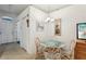 Bright dining area with a glass table and neutral decor at 30653 Pga Dr, Sorrento, FL 32776