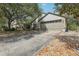 A house featuring a wide driveway that leads to an attached two-car garage at 30653 Pga Dr, Sorrento, FL 32776
