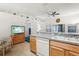 Bright eat-in kitchen with tile flooring, ceiling fan, and plentiful cabinet space at 30653 Pga Dr, Sorrento, FL 32776