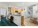 Efficient kitchen with stainless steel microwave, ample cabinetry, and an adjacent breakfast bar at 30653 Pga Dr, Sorrento, FL 32776