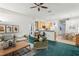 Cozy living room seamlessly flows into the kitchen and dining area, perfect for entertaining at 30653 Pga Dr, Sorrento, FL 32776