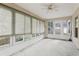 Enclosed sunroom featuring multiple windows with views of the outdoors and a ceiling fan at 30653 Pga Dr, Sorrento, FL 32776