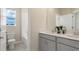 Bathroom features double sinks with stylish gray cabinets and a walk-in shower at 614 Terrapin Dr, Debary, FL 32713