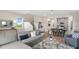 Inviting living room with a comfortable gray sofa and open layout with lots of light at 614 Terrapin Dr, Debary, FL 32713