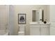 Bright bathroom includes white cabinets, a single vanity, and a bathtub with shower, creating a spa-like feel at 698 Peroni Ave, Debary, FL 32713