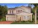Charming two-story home features a red front door, attached garage, and manicured landscaping at 698 Peroni Ave, Debary, FL 32713