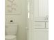 All-white bathroom featuring a toilet and vanity with soft lighting and natural accents at 703 Peroni Ave, Debary, FL 32713