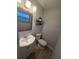 Cozy bathroom features wood-look flooring, modern vanity and toilet at 917 Adamson Ct, Lake Alfred, FL 33850
