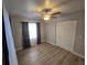 Bedroom features wood flooring, a ceiling fan, a double-door closet and natural light at 917 Adamson Ct, Lake Alfred, FL 33850