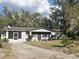 Charming single-story home features a screened porch, fresh paint, and manicured landscaping at 917 Adamson Ct, Lake Alfred, FL 33850