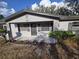 Charming single-story home with a gray exterior, a well-maintained front yard, and landscaping at 917 Adamson Ct, Lake Alfred, FL 33850