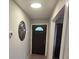Bright hallway with a decorative oval mirror and a stylish new front door at 917 Adamson Ct, Lake Alfred, FL 33850