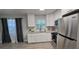 Modern kitchen featuring stainless steel appliances, granite countertops, and white cabinets at 917 Adamson Ct, Lake Alfred, FL 33850