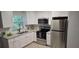 Bright kitchen features granite countertops, stainless steel appliances and white cabinets at 917 Adamson Ct, Lake Alfred, FL 33850