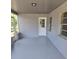 Screened-in patio of a home with a door and windows at 917 Adamson Ct, Lake Alfred, FL 33850