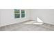A bright bedroom featuring plush carpet, large windows and white walls at 1411 Hamilton Way, Lake Alfred, FL 33850